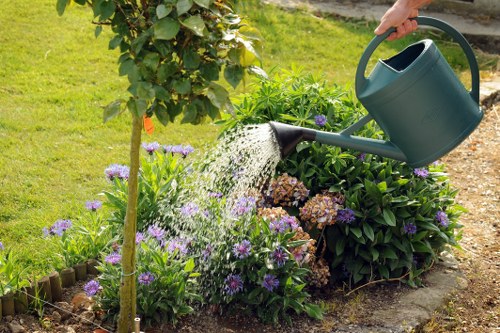 Garden maintenance worker trimming shrubs in Barbican communal area